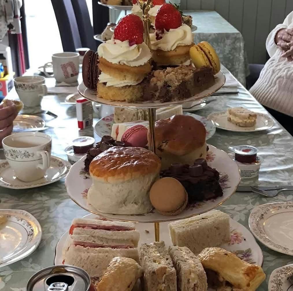A full afternoon tea stand with sandwiches, scones and homemade cakes at the Gardeners Rest