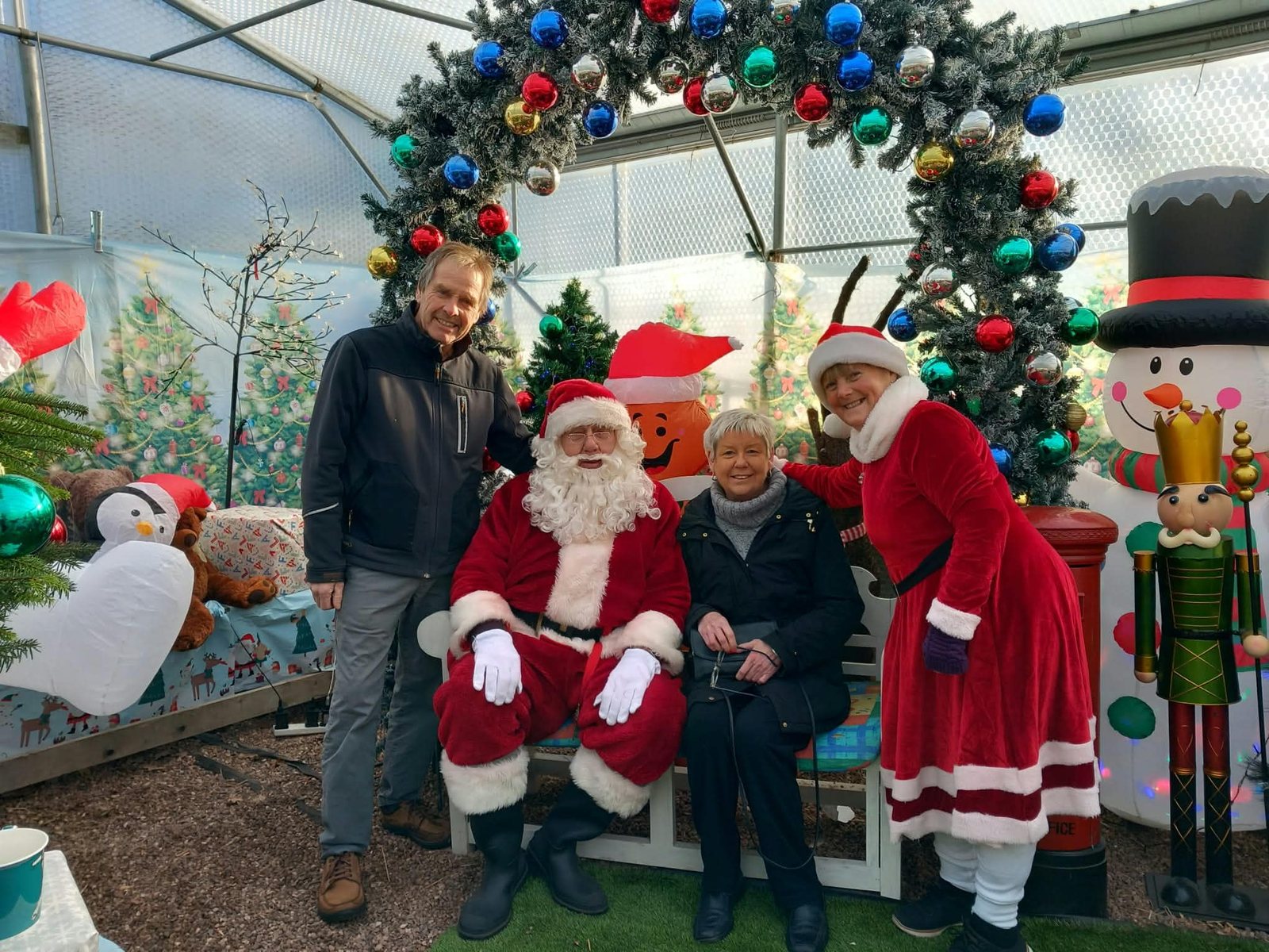 Santa and Mrs Claus with visitors in the grotto at Orchard Nurseries